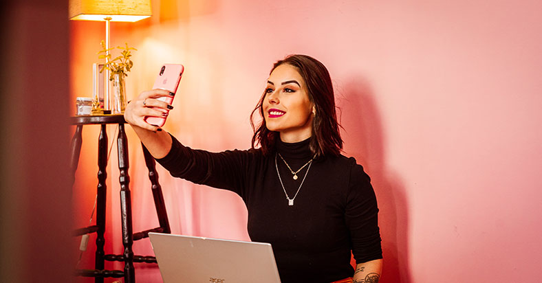 woman taking selfie with phone